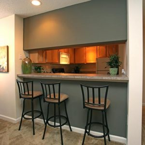 Model unit breakfast bar featuring modern furniture and decor