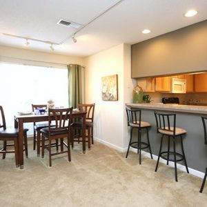 Model unit living area featuring modern finishes and furniture